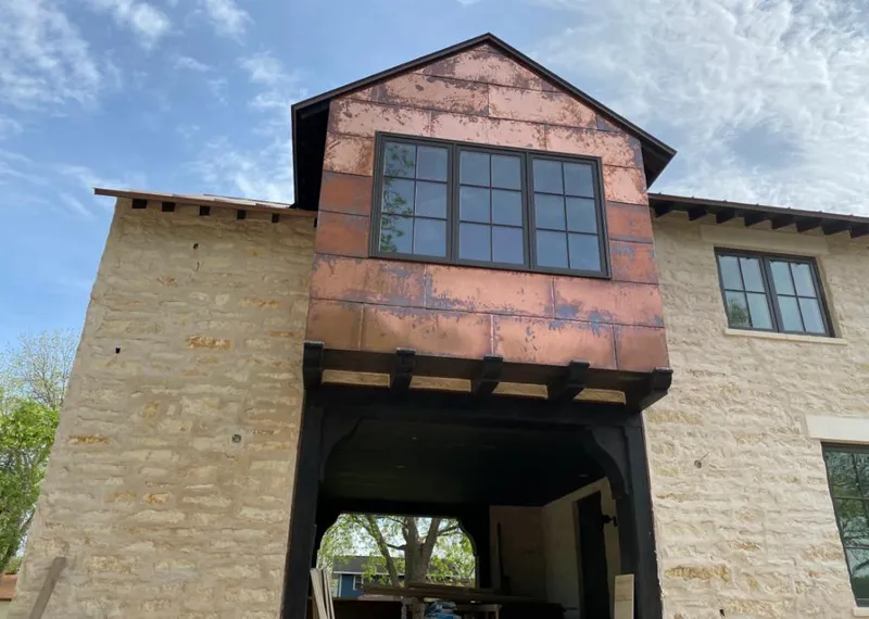 Copper metal panel facade on a stone building for Skylight Installation in Round Rock