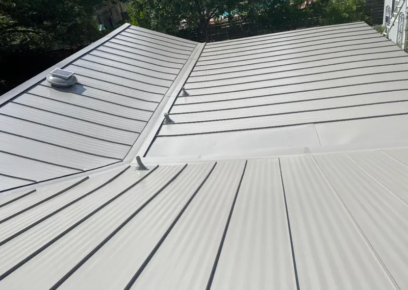 Solar attic fan installed on a metal roof for Roof Ventilation in Round Rock